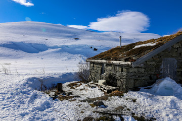 Stone cottage and winter and sun with great ski conditions on Tosenfjellet in Grane municipality, Northern Norway