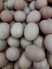 A collection of raw chicken eggs sold in the market.