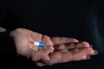 A tablet that treats ailments of a serious infectious disease given on a woman's hand.