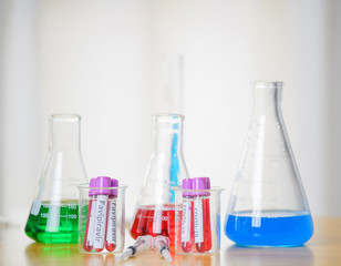 A microbiologist with a Coronavirus contaminated biological sample tube labeled with Covid-19 and the Favipiravir vaccine is used for the prevention of immunity and the treatment of coronal virus 