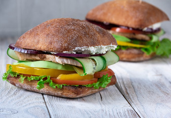 juicy fresh homemade meat burger on wooden kitchen table close-up, rustic style light planks background