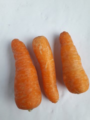 Three carrots on a white background. Good for grocery stores and more.