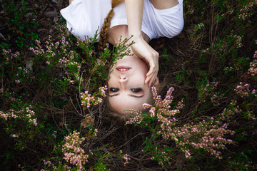 Young girl lying in grass and flowers