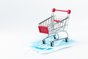 Medical mask in shop trolley on white background. Sale of medical masks. Coronavirus concept. 2019...