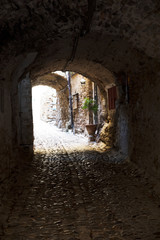 Fototapeta premium Bussana Vecchia (IM), Italy - December 12, 2017: A typical house and pathway in Bussana Vecchia, Imperia, Liguria, Italy
