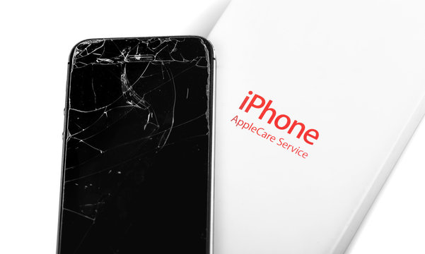 AppleCare box and broken iPhone, cracked screen. Apple is a multinational technology company. Moscow, Russia - May 21, 2018