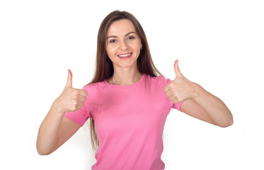 Very good! Young woman in a pink sweater shows a thumbs up, is isolated on a white background and looks at the camera.