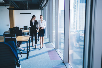 Happy businesswomen in modern high rise office