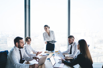 Male employee reporting work results to female boss