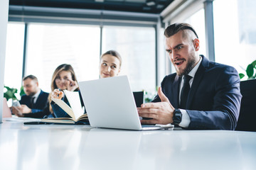 Furious unhappy businessman looking at laptop