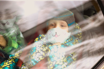 young children sit in colored respirators during the coronavirus epidemic