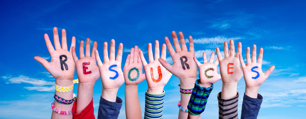 Children Hands Building Colorful Word Resources. Blue Sky As Background