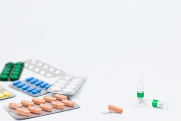 Medicine, capsules in blister, tablets, injection, syringe and needle. Close-up of various drugs