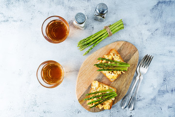 Scrambled egg asparagus sandwich with glasses of tea