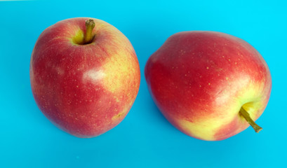 two red apples on a blue background
