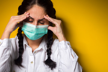 A woman of 40 years old is wearing a medical mask and is in a home quarantine that protects against infection against coronavirus covid-19