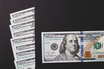 Dollars on a black background, close-up.