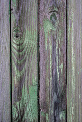 Old fence made of wooden planks, in the style of rustic, grunge, old fashion, worn gray-green color with nails