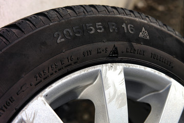 a lot of car black tires with different tyre tread stack together in a group. 