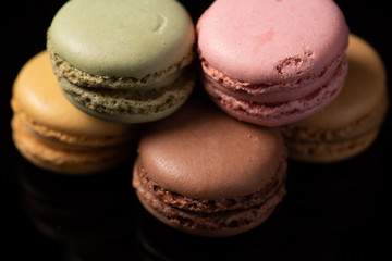 macaroons isolated in reflective black background