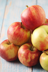 Several ripe red apples on the wooden table	