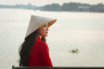 Portrait of Vietnamese girl traditional red dress,Beautiful young asian woman wearing Vietnam