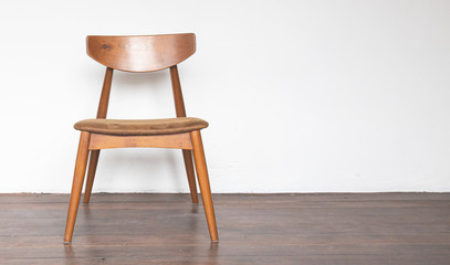 Vintage wooden chair on on wooden parquet floor.
