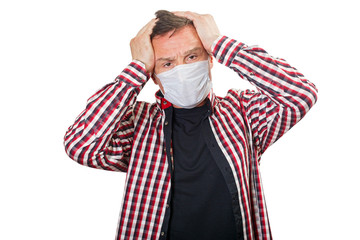 Adult male with a headache in a medical mask