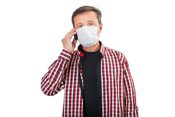 Sick man in a medical mask calls a doctor