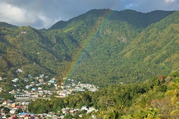 Fototapeta na wymiar View of a rainbow over the town of Soufriere in St Lucia, West Indies