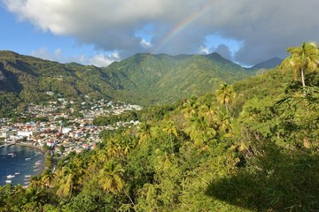 Fototapeta na wymiar View of a rainbow over the town of Soufriere in St Lucia, West Indies
