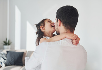 Happy father with his daughter embracing each other at home
