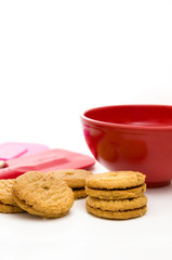 Cookies with Red Bowl and Red and Pink Spatula Isolated on White