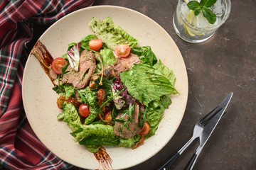 Warm salad with beef, cherry tomatoes and sun-dried tomatoes. Healthy food
