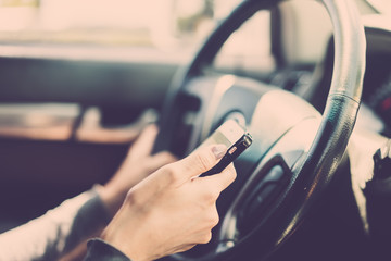 Woman using smartphone during traffic jam on road. vintage filter