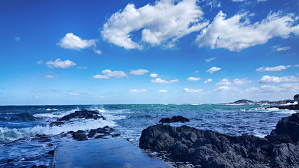 Fototapeta na wymiar 파란하늘 흰구름 바다 파도 해변