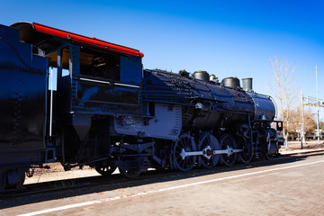 Fototapeta na wymiar Close view of an old steam iron big locomotive on the station in Arizona, USA