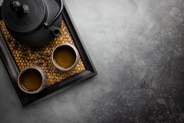Green japanese tea on black stone table. Top view with copy space