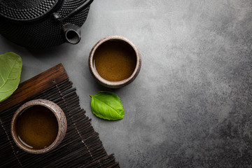 Green japanese tea on black stone table. Top view with copy space