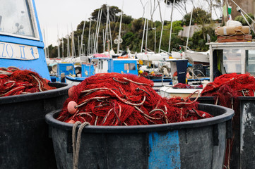 fishermans boats in little harbor with nets drying in the sun