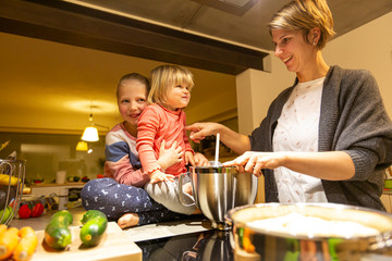 Mother and daughter having fun in the kitchen during cooking