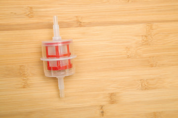 Fuel diesel filter on a wooden background. Auto parts.