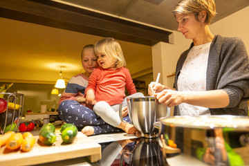 Mother and daughter having fun in the kitchen during cooking