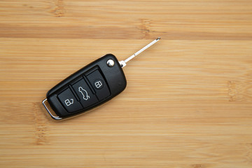 Car key on a wooden background. Production of car keys.