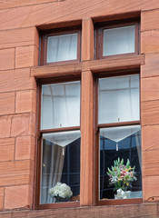 Wooden window with flower pots in Old City of Glasgow