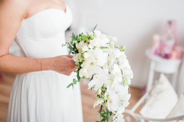 wedding bouquet in hands of bride