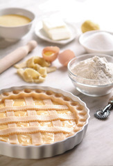 Uncooked Sweet Pie/Tart on Plate, Made in Italy with Ingredients on Kitchen Counter