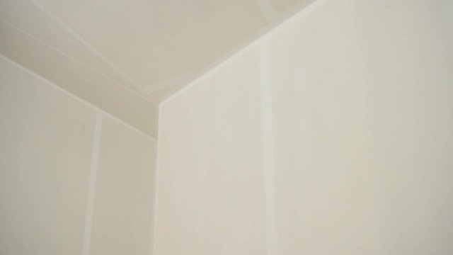 room prepared for renovation with slow motion along corne with walls and ceiling