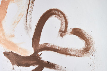 The pattern is drawn with a heart-shaped brush painted on a white background with cream foundation