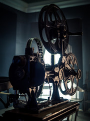 Old vintage movie projector on a dark background